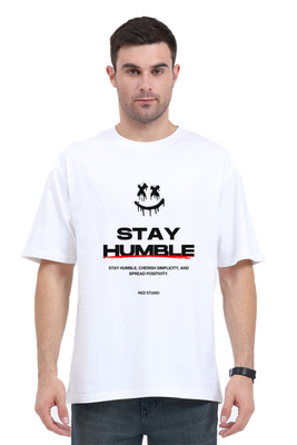 A smiley face with X-eyes and the text Stay Humble – Oversized T-shirt by Rizz Studio