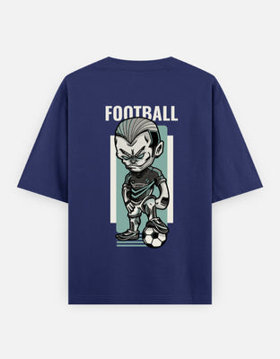 Oversized t-shirt featuring a sharp-edged cartoon footballer standing over a football with intense expression and bold graphic style — perfect for streetwear and sports lovers.