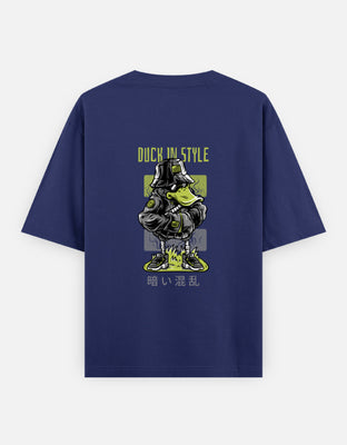Oversized t-shirt with graphic of a cool duck in bucket hat, sunglasses, and sneakers, standing with crossed arms. Text reads “Duck In Style” with Japanese script at bottom.