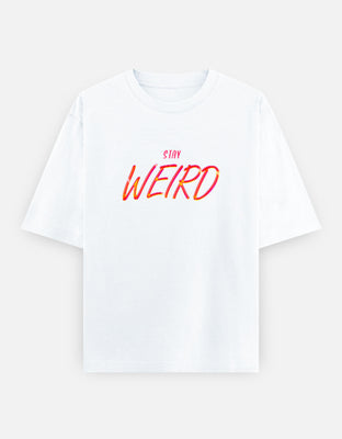 Oversized black t-shirt with glowing neon pink and yellow “Stay Weird” text in bold script, symbolizing individuality and eccentric street style.