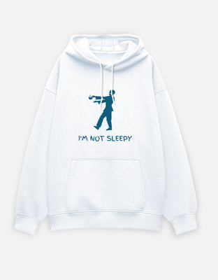 Oversized white hoodie with blue zombie silhouette holding coffee and the text “I’m Not Sleepy.”
