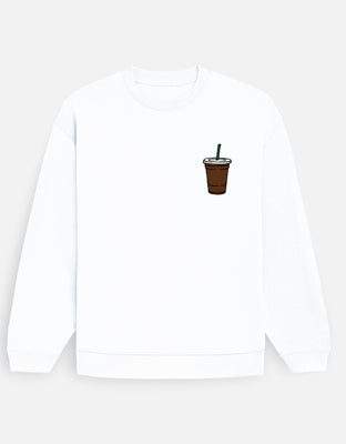 Oversized white sweatshirt with a small left-chest iced coffee cup graphic featuring a green straw.
