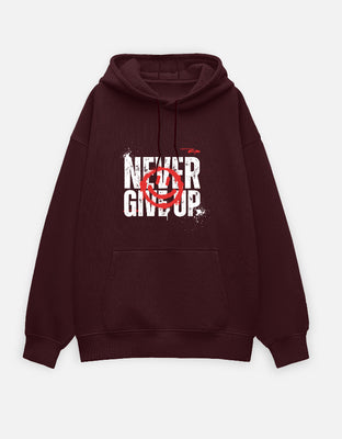 Oversized maroon hoodie with bold white distressed “Never Give Up” text and a red graffiti-style overlay graphic on the front.