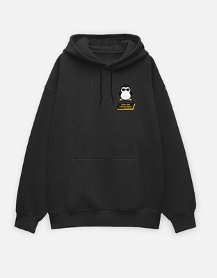 Black oversized hoodie with a pixel-art penguin wearing sunglasses and yellow “Cuteness Increased” retro text.
