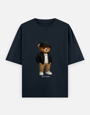 Oversized t-shirt featuring a teddy bear in black cap, bomber jacket, white tee, khaki pants, chain, and white sneakers — clean streetwear fit.