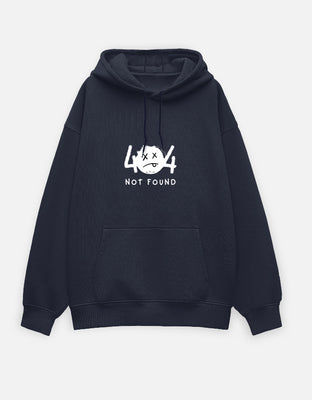 Black oversized hoodie with minimalist white “404 Not Found” graphic and sad-face emoticon printed on the front center.