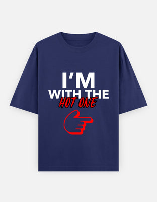 Black oversized t-shirt with bold white and red text saying "I'm With the Hot One" and a red pointing finger — designed for couples with humor and confidence.